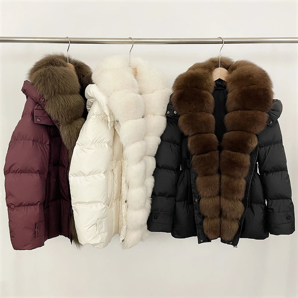Four puffer jackets with fur collars on a rack 