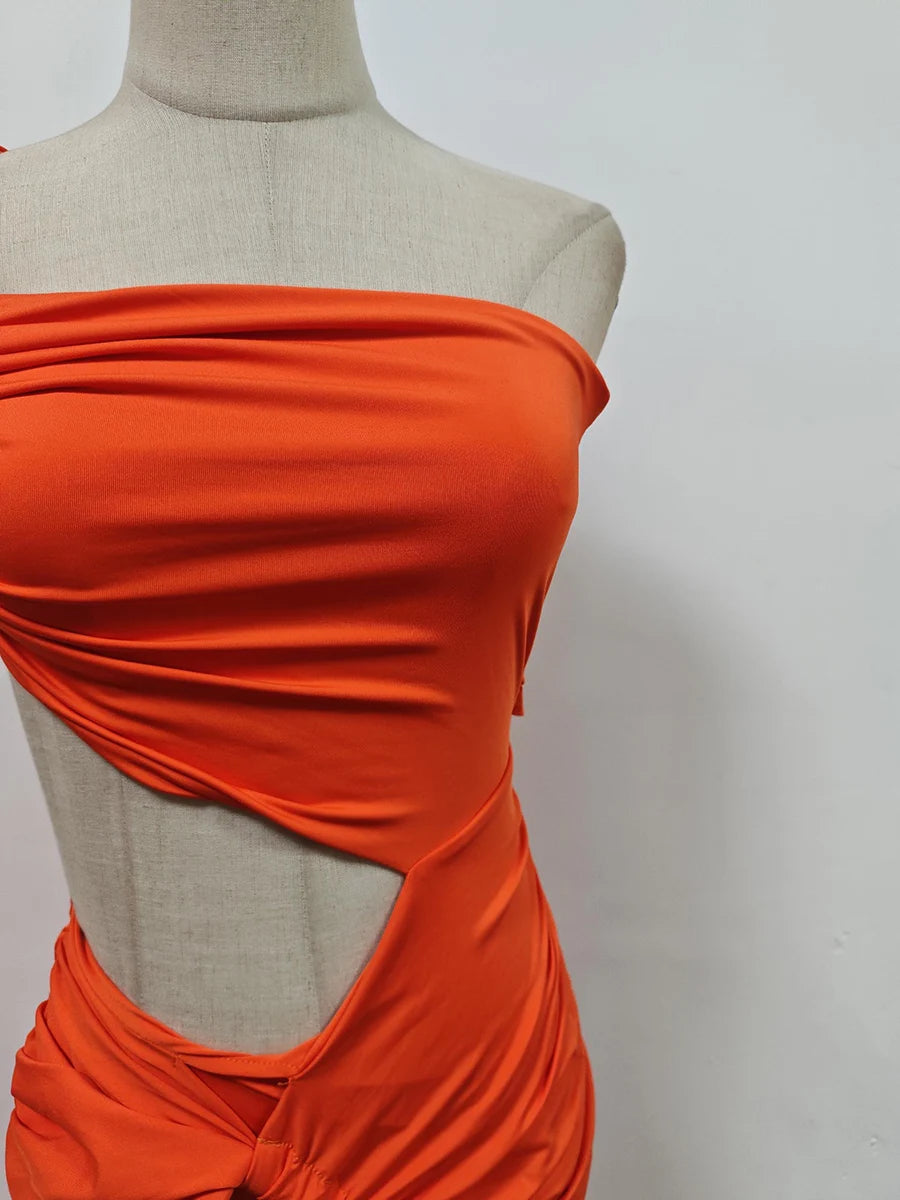 Orange strapless dress on a mannequin against a plain background
