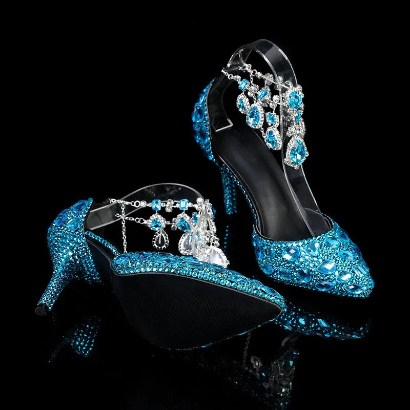 Blue high-heeled shoes with intricate designs on a black background