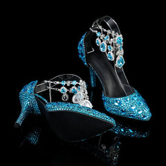Blue high-heeled shoes with intricate designs on a black background