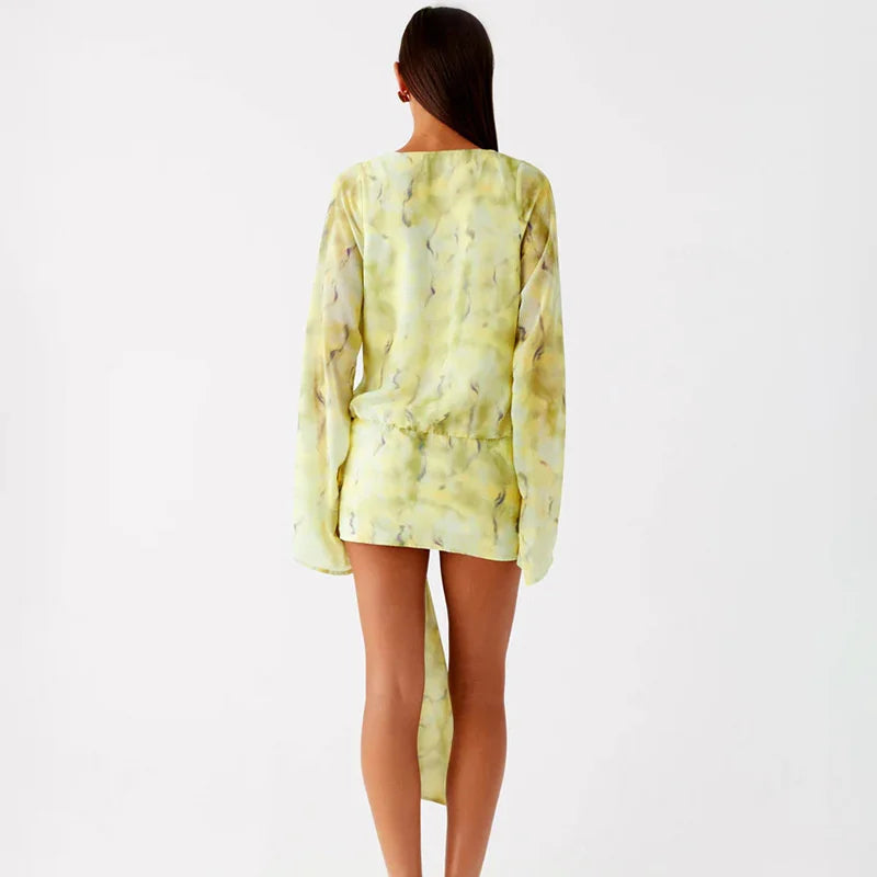 Woman wearing a light green dress with a subtle pattern