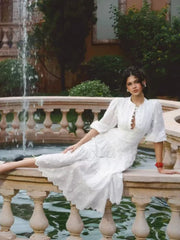 White embroidered puff sleeve midi dress side pose