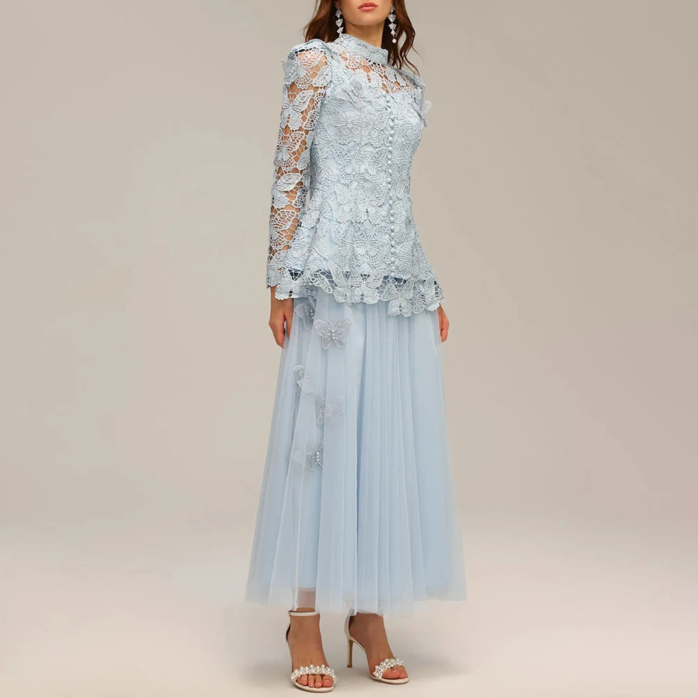 Light blue lace dress with matching top on a neutral background