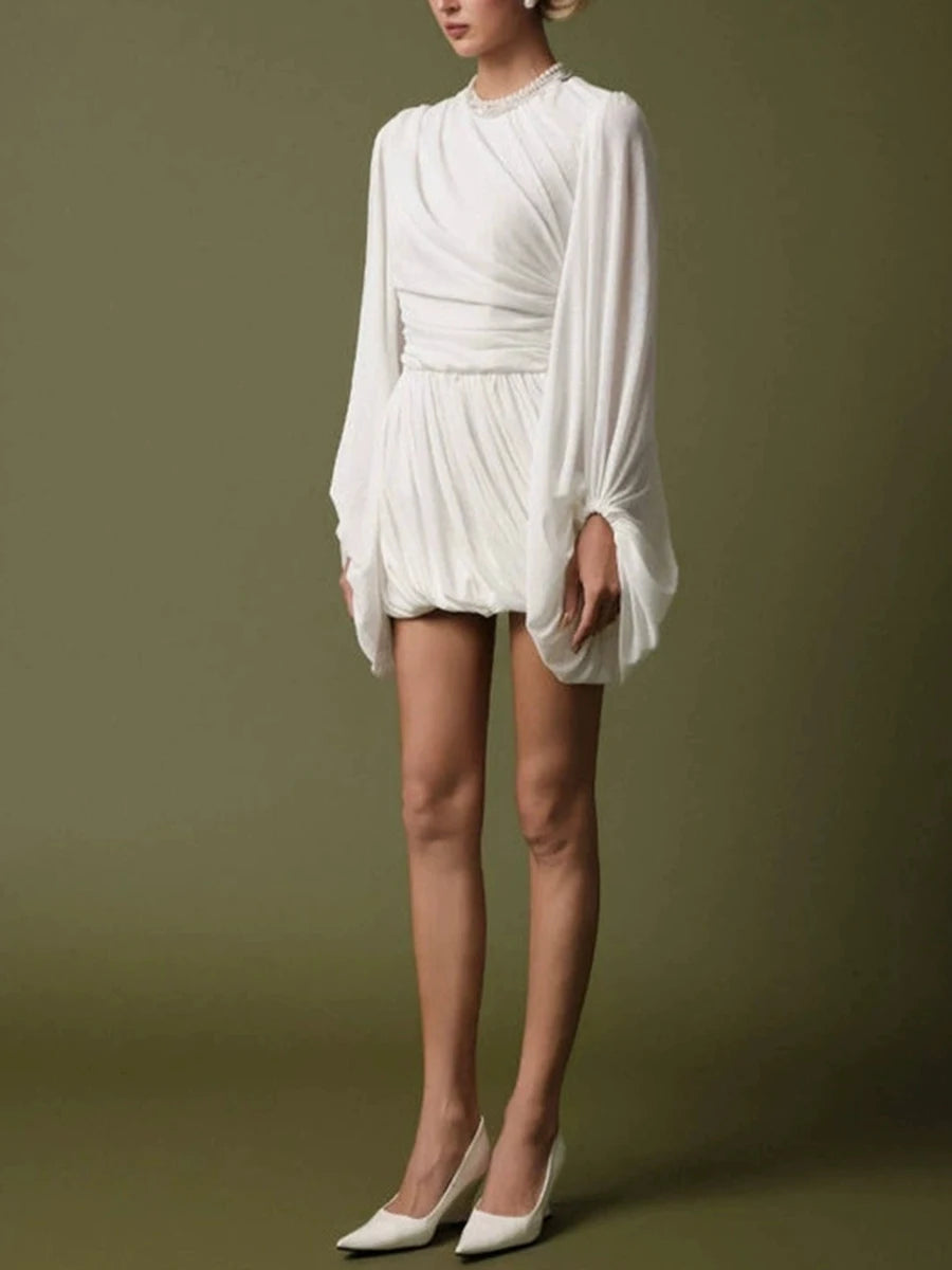 Side profile of long sleeve draped mini dress