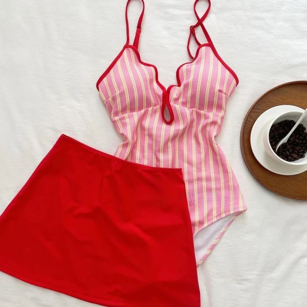 Pink striped bikini top and red skirt