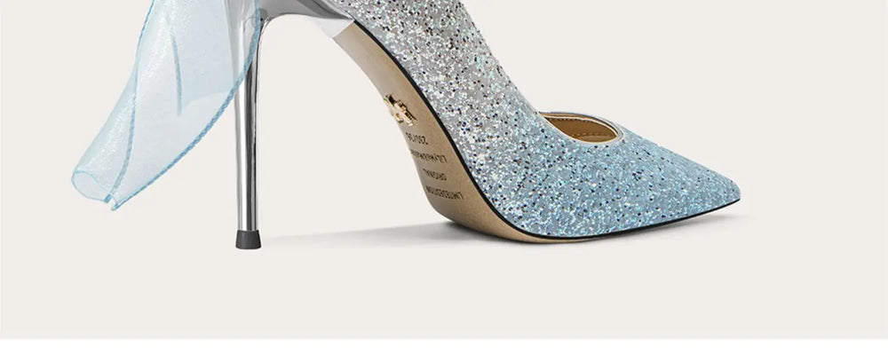 Blue glitter high-heeled shoe on a light gray background