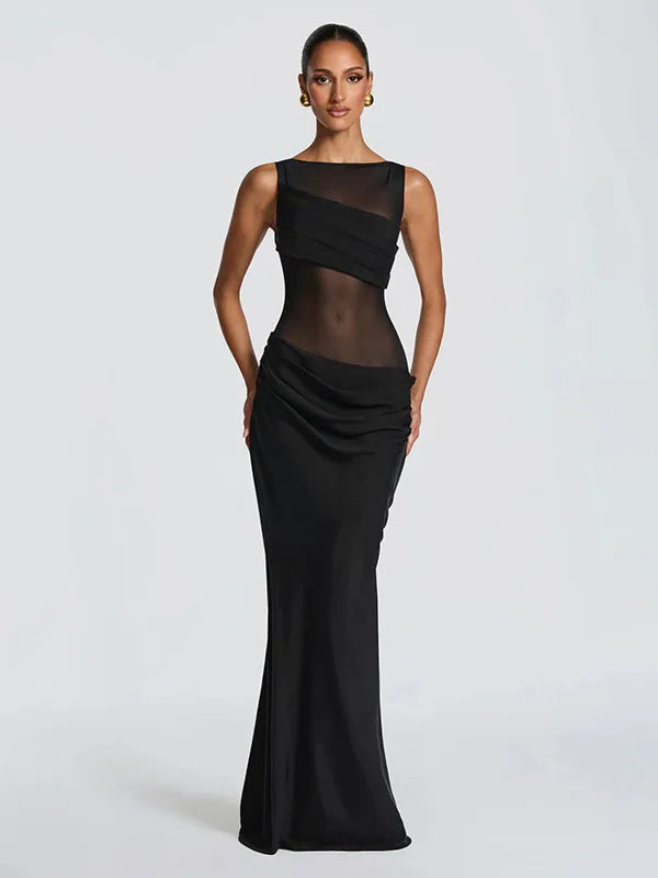 Black evening gown with sheer overlay on a white background