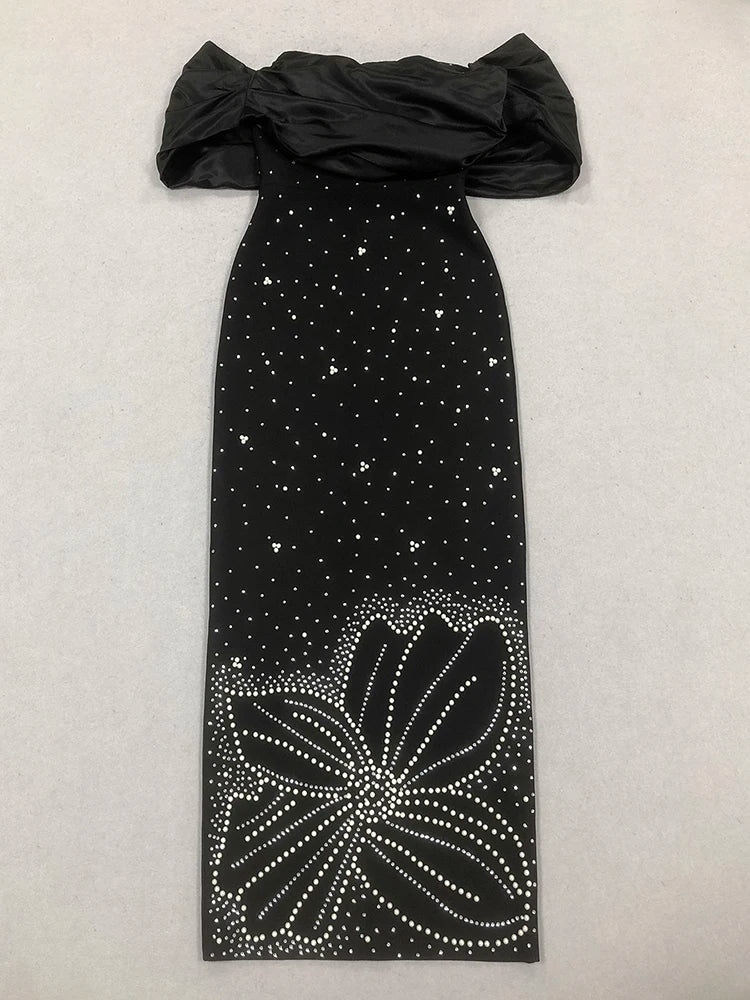 Black off-shoulder dress with floral embellishments on a light gray background