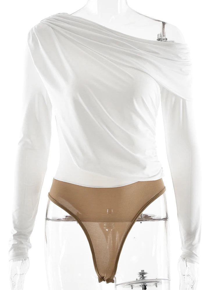 White long-sleeve top with a sheer overlay and beige thong on a mannequin against a white background.