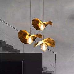 A  Stair Case illuminated by a brass lotus leaf pendant light creating a tranquil atmosphere.