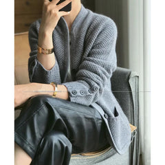 A woman wearing a luxurious Dark Grey 100% cashmere cardigan, showcasing its elegant drape and warmth. Golden Atelier 4