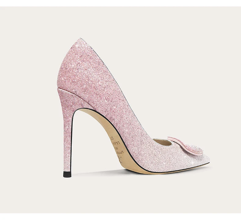 Pink glitter high heel shoe on a light gray background