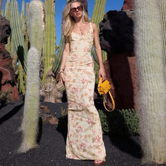 Woman in a floral dress standing among cacti