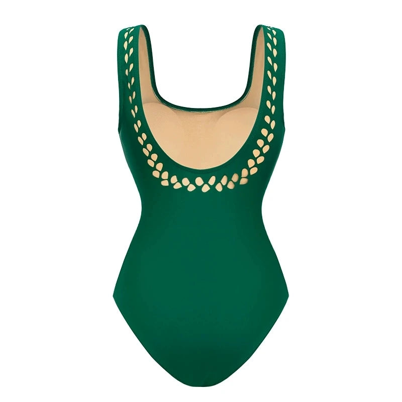 Back view of green cut-out embellished one-piece swimsuit.
