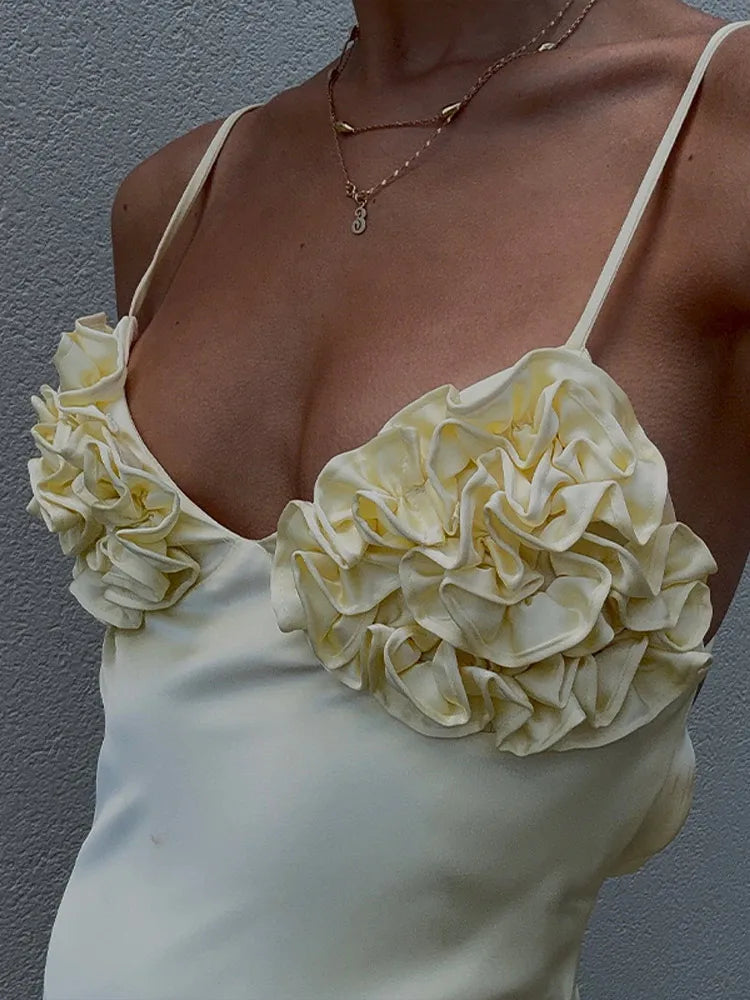 Cream-colored top with floral detailing on a plain background