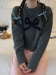  Women's sweater with a bow accent and an O-neck.