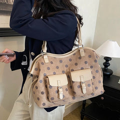 Beige polka dot faux leather tote bag with dual front pockets