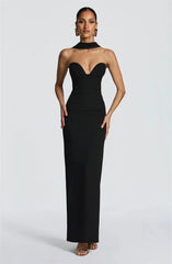 Woman wearing a black strapless gown on a white background