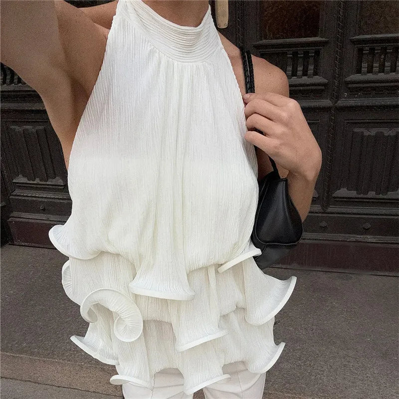 Back detail of white halter neck ruffle crop top.