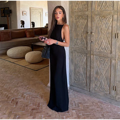 Full length view of a woman wearing a polka dot maxi dress with beaded straps.