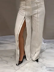 Beige pants with a high slit on a marble floor