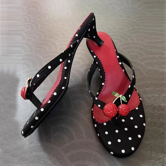 Side view of polka dot kitten heel flip flops with cherry embellishment