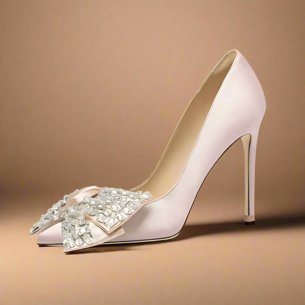 High-heeled shoe with decorative bow on a light gray background
