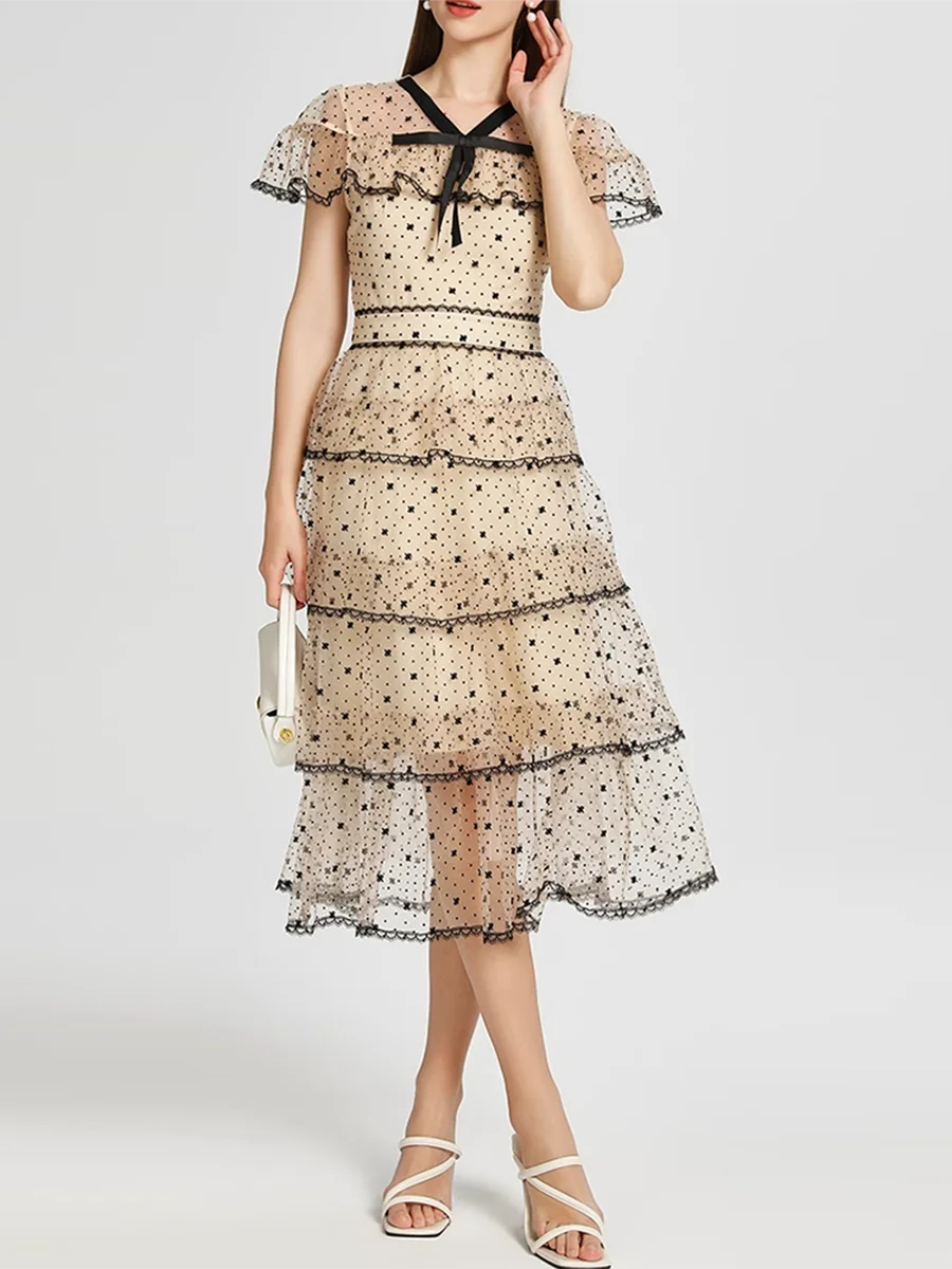 Woman wearing a beige floral dress with a white background