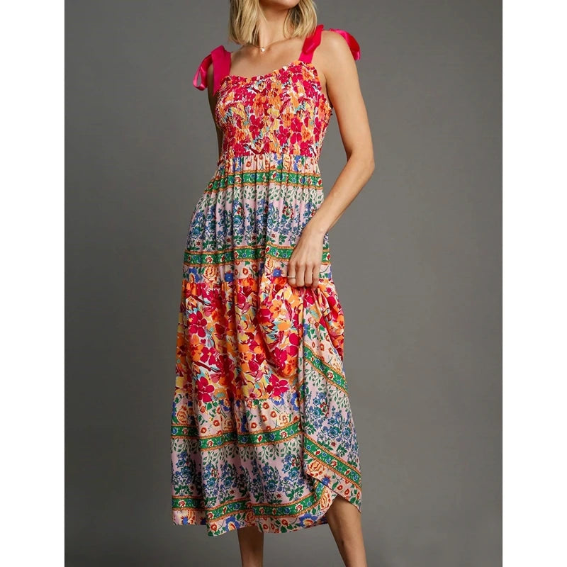 Multi-colored floral patchwork print smocked square neck maxi dress with pink tie shoulder straps.