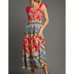 Multi-colored floral patchwork print smocked square neck maxi dress with pink tie shoulder straps.