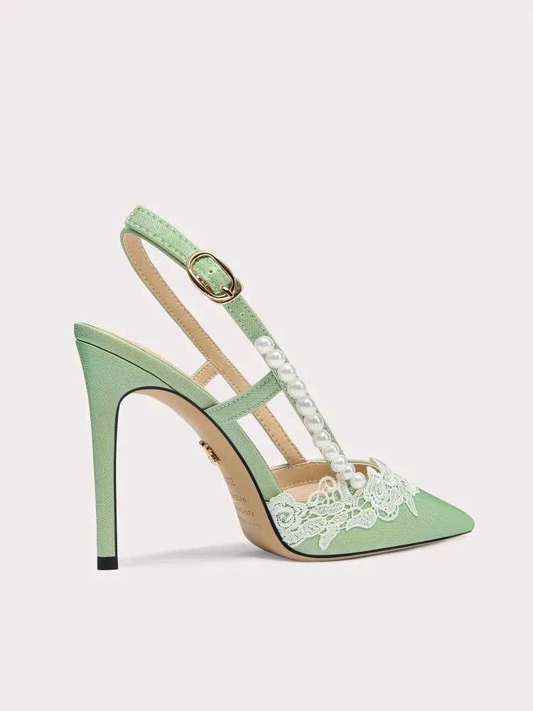Mint green high-heeled shoe with lace detailing on a light gray background