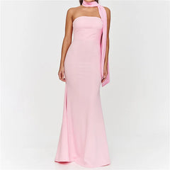 Pink halter neck gown with a draped fabric detail on a white background