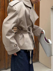 Model wearing belted double-breasted jacket