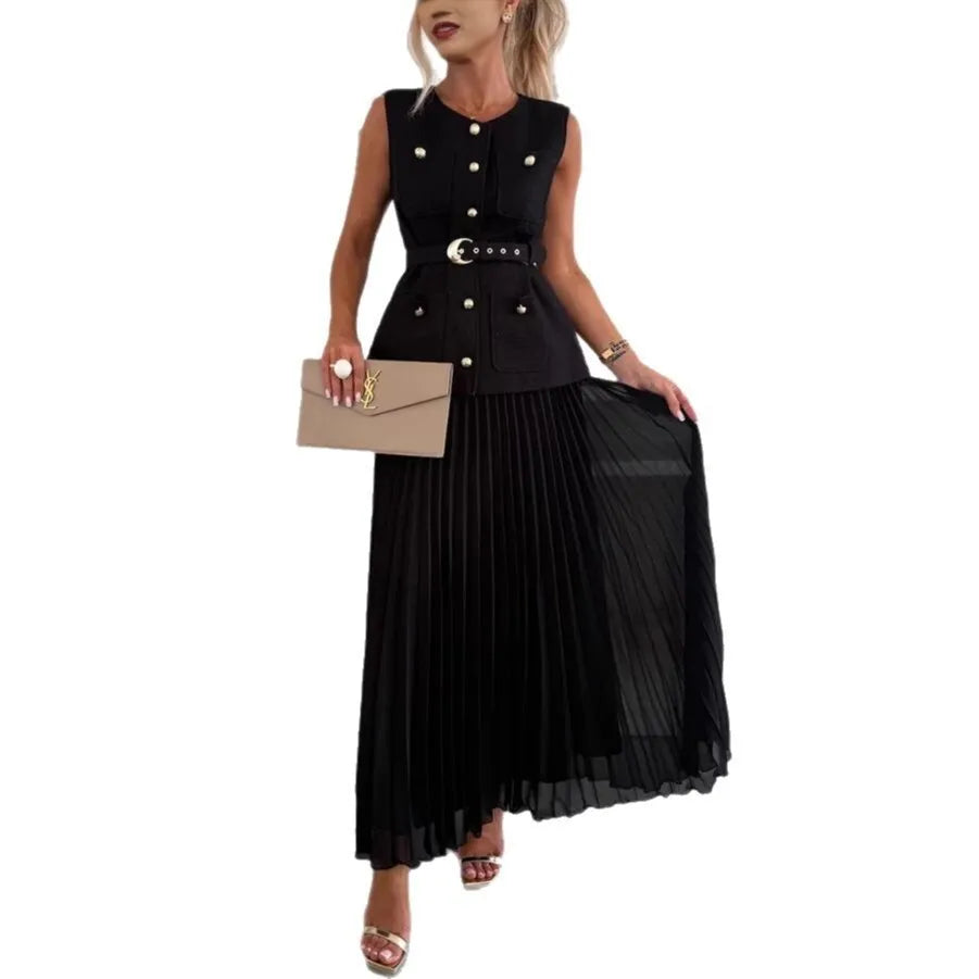 Woman wearing a black sleeveless top with buttons and a pleated black skirt on a white background