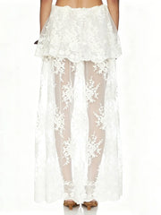 Back view of white floral lace high neck sleeveless crop top and sheer maxi skirt set