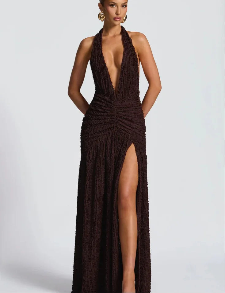 Woman wearing a brown halter neck dress with a high slit