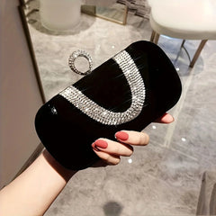 A glamorous rhinestone clutch purse with a delicate chain strap, showcasing its sparkling design.