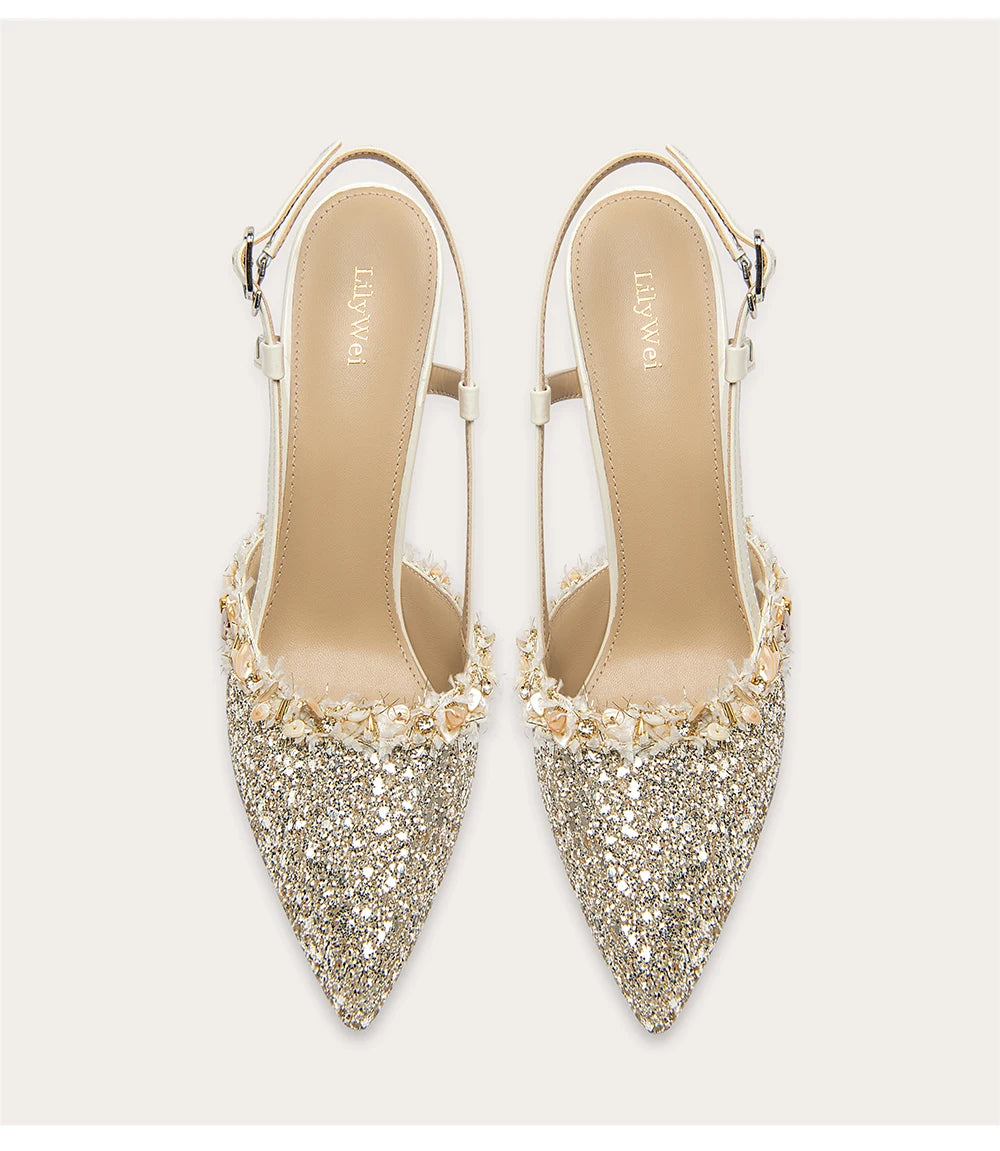 Pair of glittery high-heeled shoes on a light background