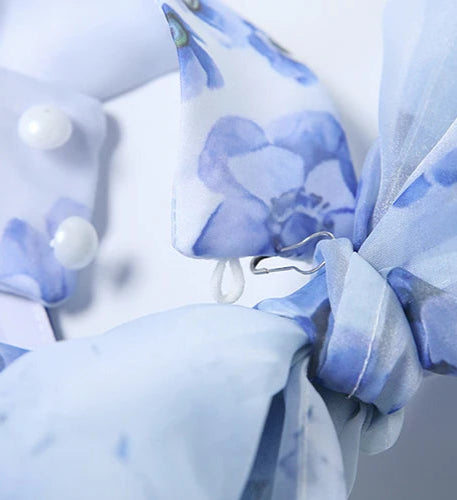 Close-up of a blue and white floral fabric with a blurred background