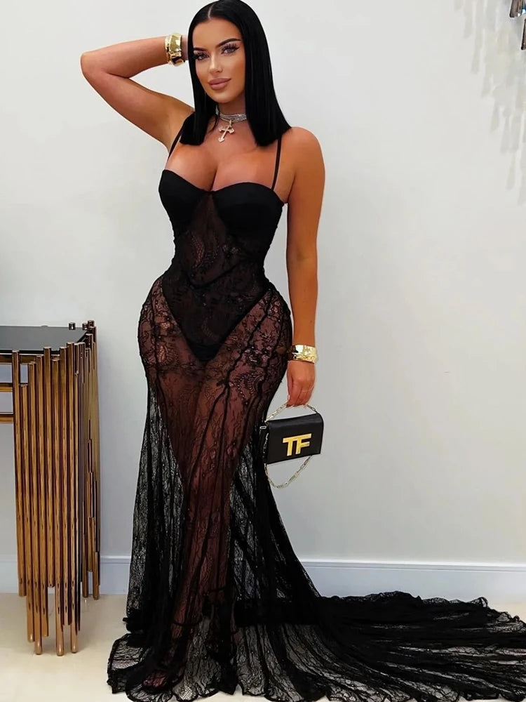 Woman wearing a black lace evening gown with a white background