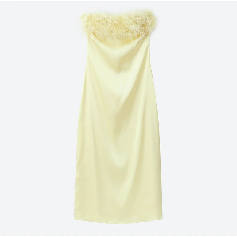 Light yellow strapless dress with textured fabric on a white background