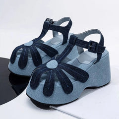Denim platform sandals with flower detail and T-strap.
