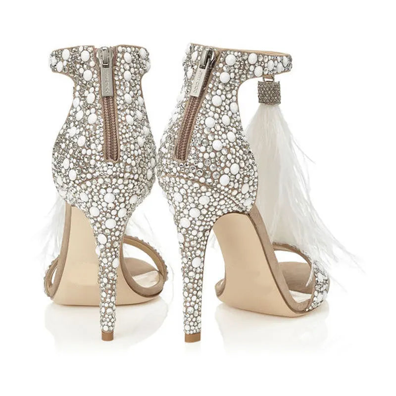 Back view of feather embellished stiletto heels with zipper closure and crystal accents.