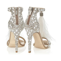 Back view of feather embellished stiletto heels with zipper closure and crystal accents.
