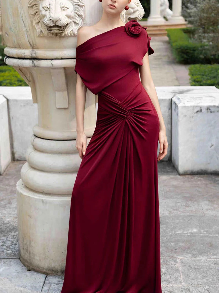 Close-up of draped detail on one shoulder dress