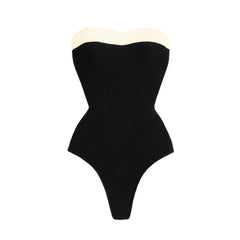 Textured black swimsuit with cream trim.