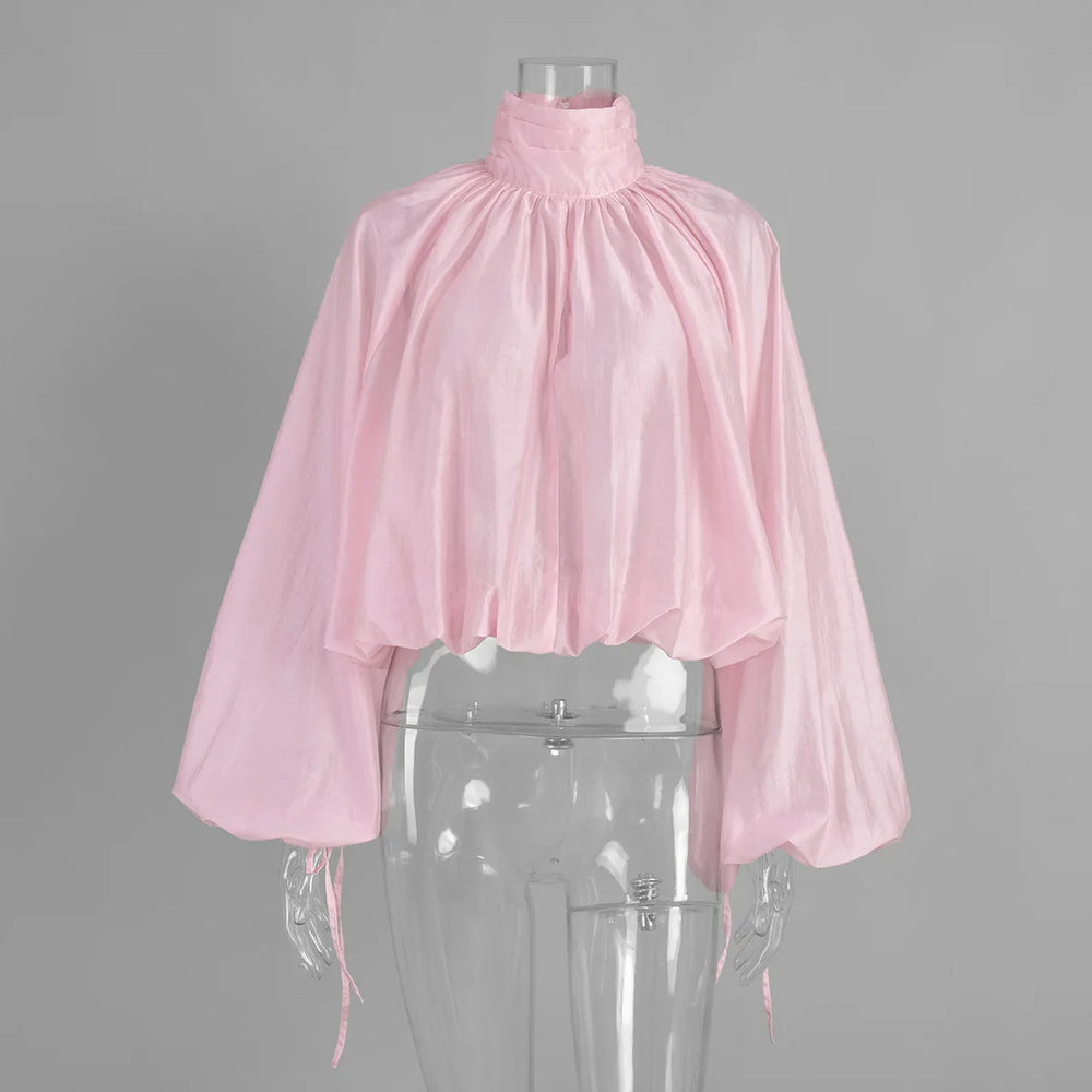 Pink blouse on a transparent mannequin against a gray background