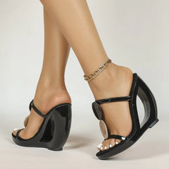 Black patent leather wedge sandals with hollow-out heel and shell detail