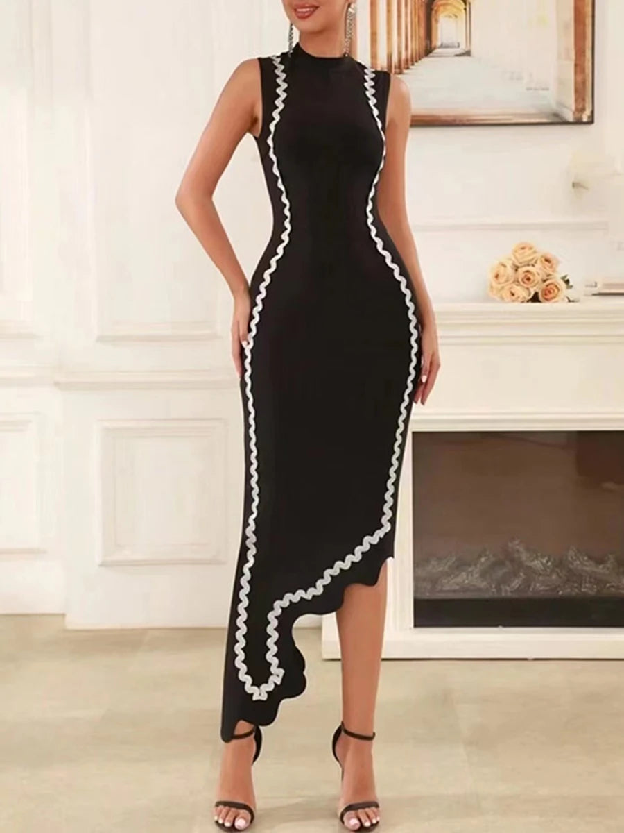 Woman wearing a black dress with white trim in an indoor setting