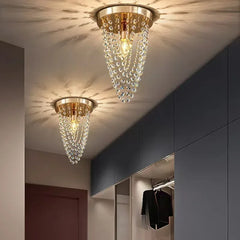 A sleek crystal ceiling lamp with a minimalist design, casting a warm glow in a modern bedroom.  Golden Atelier 4